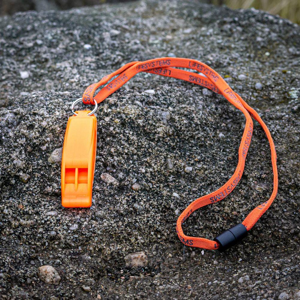 Lifesystems Safety Whistle on a rock