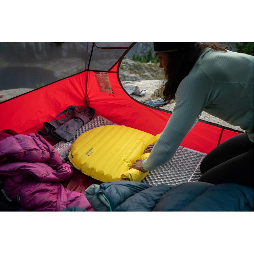 Thermarest NeoAir XLite NXT Sleeping Mat - Regular (Lemon Curry) rolling it up